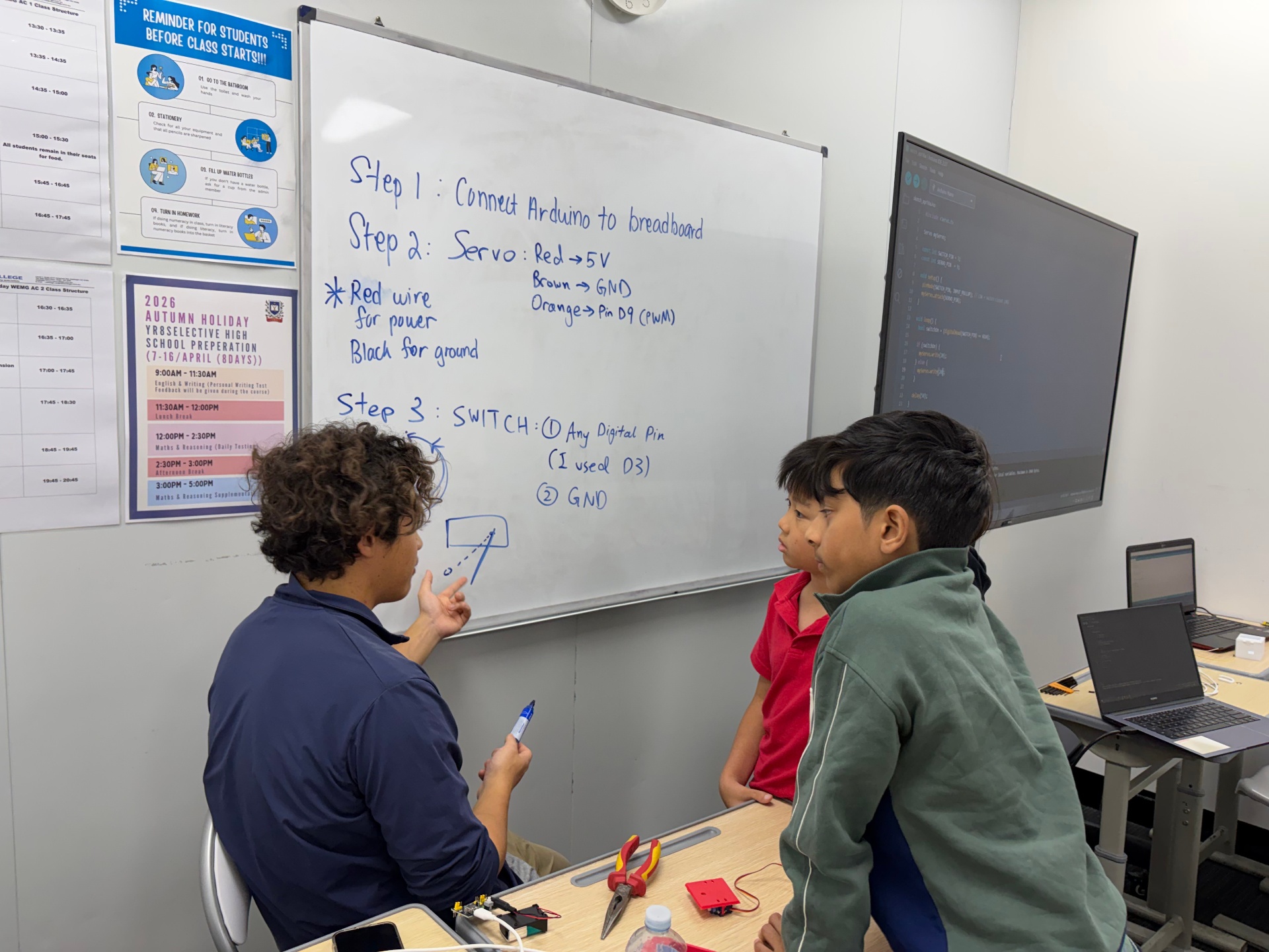 EBK Academy instructor teaching students robotics and Arduino