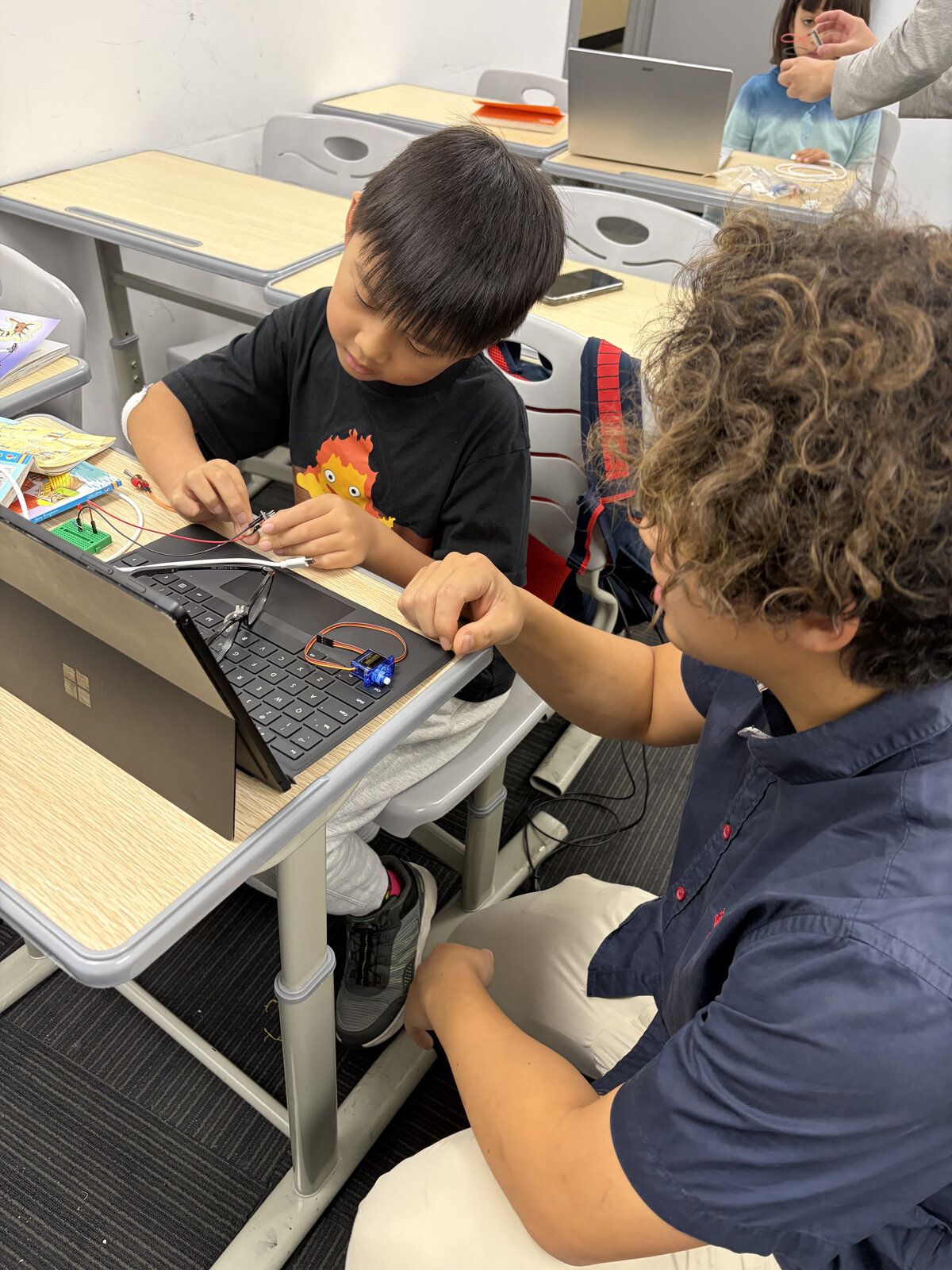 EBK Academy instructor teaching a student during a hands-on STEM session